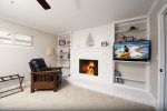 The master bedroom has a gas fireplace and a flat-screen tv.